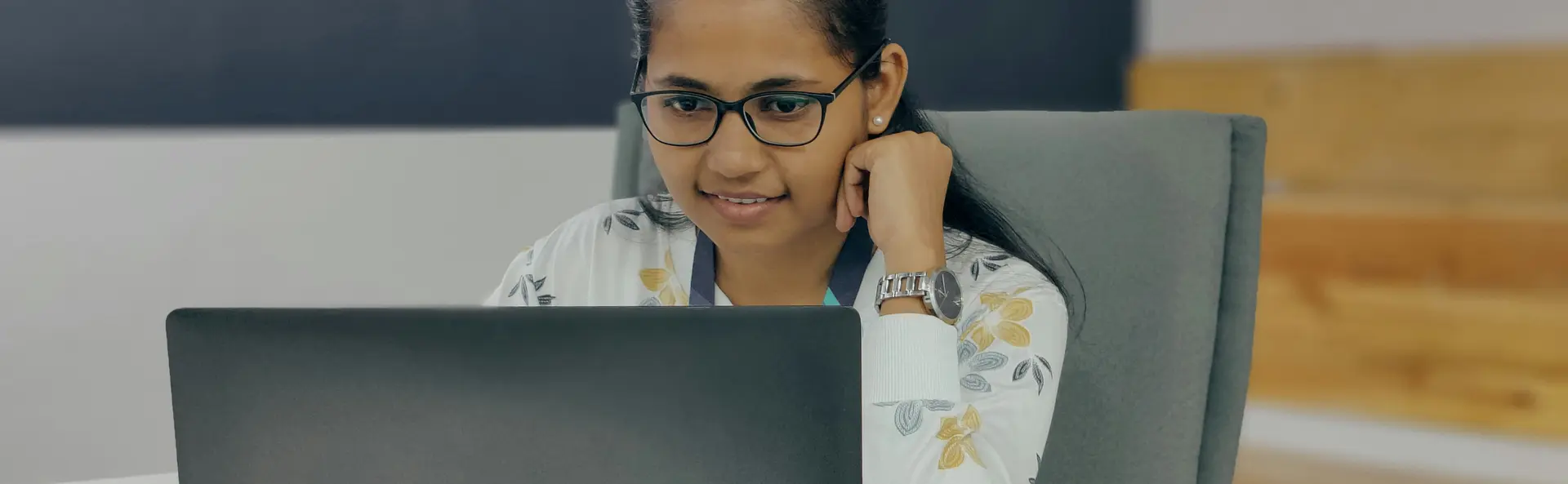 Professional looking at laptop in office.
