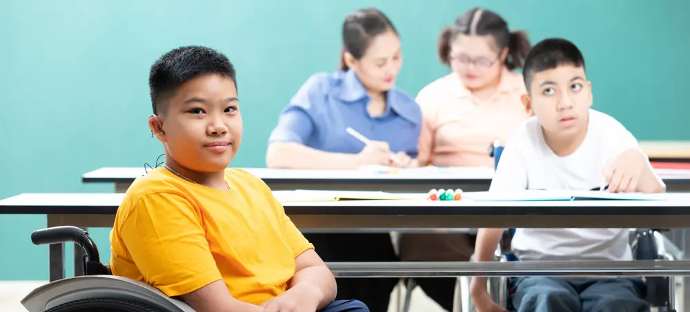Three students with disabilities sitting in a classroom