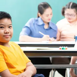Three students with disabilities sitting in a classroom